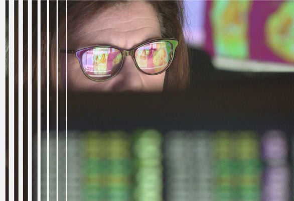 Woman at computer monitoring privileged activity