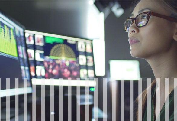 Woman working in a digital environment with computer monitors